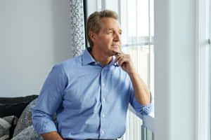 Former Senator Jeff Flake Gazing Thoughtfully Out Of The Window Wallpaper