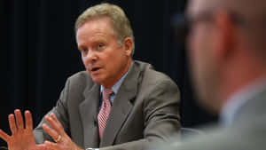 Former Senator Jim Webb Engaged In A Strategic Meeting Wallpaper