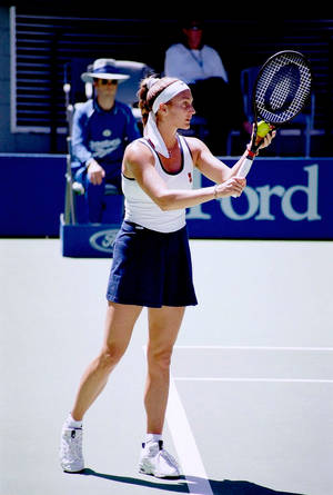 Former Tennis Star Mary Pierce Competing In White And Blue Dress Wallpaper