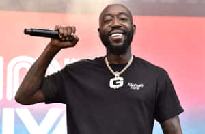 Freddie Gibbs Performingon Stage Wallpaper