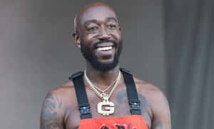 Freddie Gibbs Smiling Performance Wallpaper