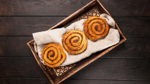 Fresh Baked Cinnamon Rolls Wooden Tray Wallpaper