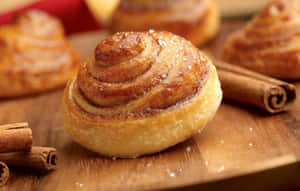 Fresh Baked Cinnamon Rollswith Cinnamon Sticks Wallpaper
