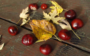 Fresh Chestnuts On A Rustic Wooden Table Wallpaper