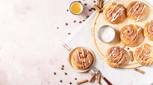 Fresh Cinnamon Rollswith Icingand Coffee Beans Wallpaper