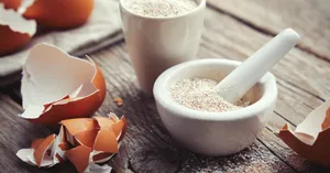 Fresh Eggshell On A Wooden Tray With A Green Backdrop Wallpaper