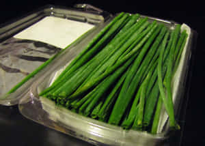 Fresh Garlic Chives On Plastic Packaging Wallpaper