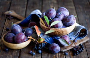 Fresh Italian Prune Plums And Blackberries In Wooden Bowls Wallpaper