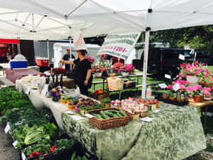 Fresh Produce On Display At A Bustling Farmers Market Wallpaper