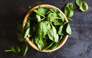 Fresh Spinach Leaves In A Wooden Bowl Wallpaper