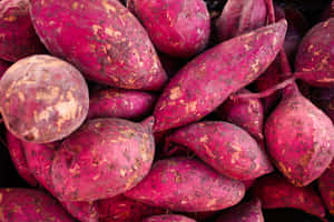 Fresh Yellow Sweet Potato On Rustic Wooden Table Wallpaper