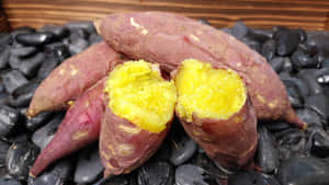 Fresh Yellow Sweet Potatoes On A Wooden Surface Wallpaper