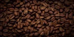 Freshly Brewed Brown Coffee With Aromatic Beans Wallpaper