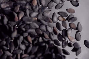 Freshly Ground Black Sesame Seeds, Ready To Be Enjoyed. Wallpaper