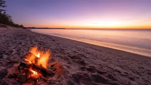 Friends Enjoying A Fall Bonfire Wallpaper