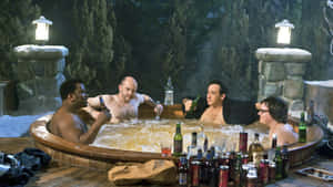 Friends Relaxingin Outdoor Hot Tubat Night Wallpaper