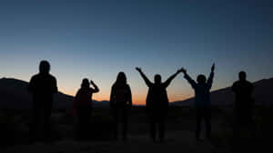 Friendship Day Silhouettesat Sunset Wallpaper