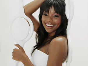 Gabrielle Union Smiling Elegantly In White Dress Wallpaper