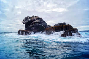 Galapagos_ Rocky_ Islet_ Surrounded_by_ Waves Wallpaper