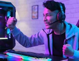 Gamer Celebrating Victoryat P C Setup.jpg Wallpaper