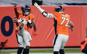 Garett Bolles Celebrating With Teammate Wallpaper