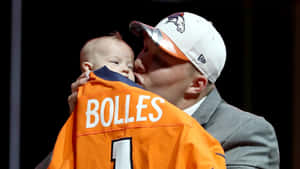 Garett Bolles Kissing His Son Wallpaper