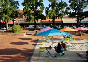 Garland Couple Enjoying A Stroll Through Downtown Wallpaper