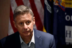 Gary Johnson In Dark Blue With Us Flag Wallpaper