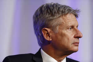 Gary Johnson Looking Sideways With A Purple Backdrop Wallpaper