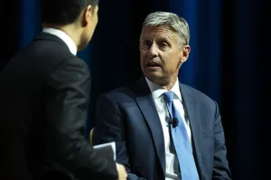 Gary Johnson Posed Against Dark Blue Curtains Wallpaper