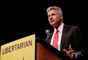 Gary Johnson Wearing Black Suit On A Podium Wallpaper