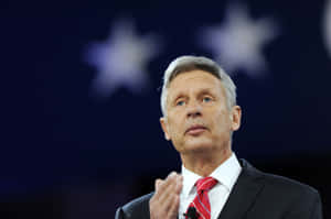 Gary Johnson With A Starry Dark Blue Backdrop Wallpaper