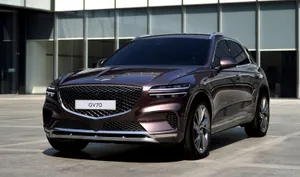 Genesis Gv70 Suv In Luxurious Desert Setting Wallpaper