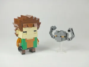 Geodude And Pokemon Trainer Toy In Action Wallpaper