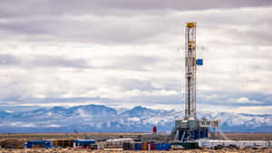 Geothermal Drilling Rig Against Mountain Backdrop Wallpaper