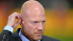 German Football Player Matthias Sammer Fixing His Earpiece Wallpaper