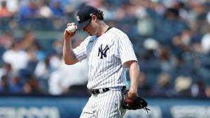 Gerrit Cole Holding A Baseball Wallpaper