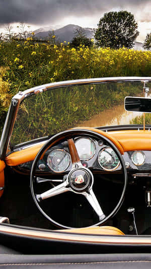 Get Behind The Wheel Of History With A Vintage Car Iphone Wallpaper