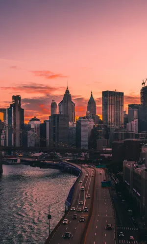 Get Lost In The Skyline Of A Beautiful City At Sunset Wallpaper