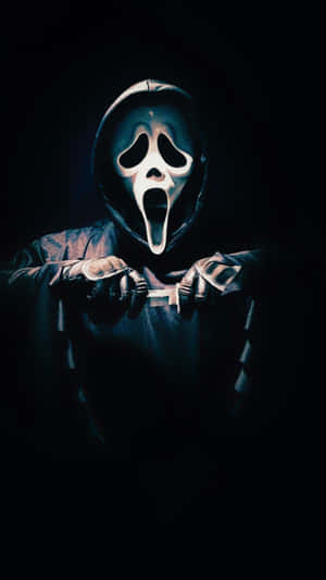 Ghostface Holding Knife Dark Backdrop.jpg Wallpaper