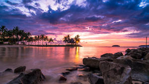 Giant Rocks On Beach During Sunset Wallpaper