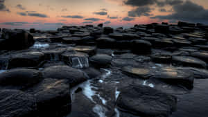 Giant's Causeway Dark Thick Clouds Wallpaper