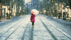 Girl Walking On Snowfall Wallpaper