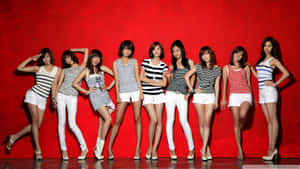 Girls Group Red Backdrop Posing Wallpaper