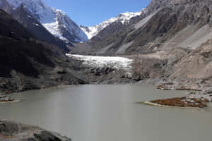 Glacial_ Lake_and_ Mountain_ Snowscape.jpg Wallpaper