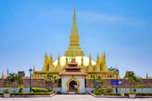 Gleaming Pha That Luang In Vientiane Wallpaper
