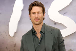 Glen Powell Smilingat Event.jpg Wallpaper