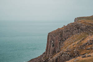 Glorious Rocky Cliffs Overlooking The Ocean Wallpaper