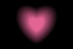 Glowing Heart Against Black Background Wallpaper