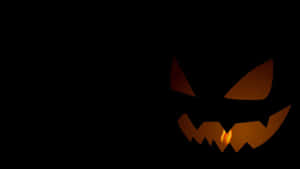 Glowing Jack O Lantern Face Dark Background Wallpaper